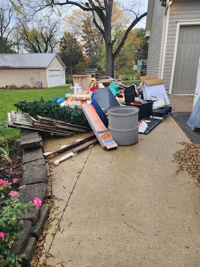 Dumpster being loaded with debris for Estate Cleanout Dumpster Rental in West Branch
